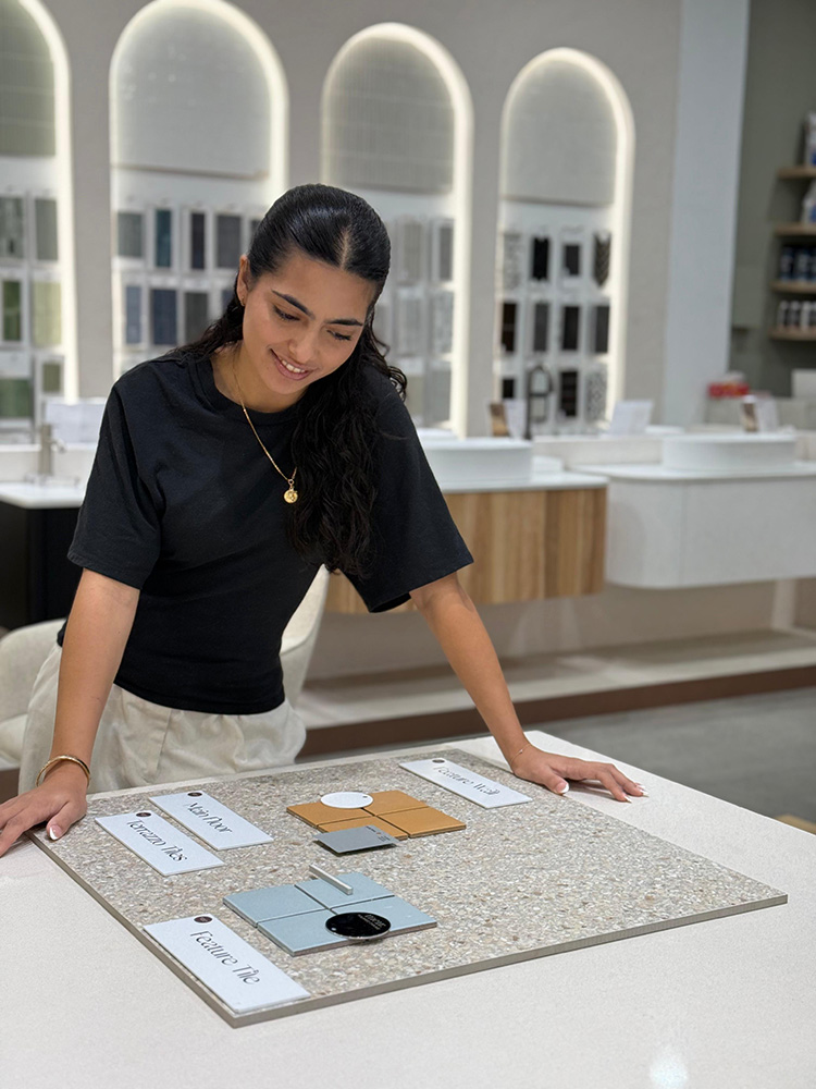 Design Tiles consultant at the Rockdale showroom consultation table with a curated Sydney bathroom tile palette.