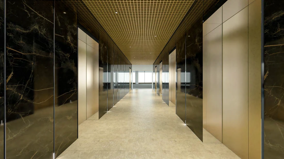 Grosvenor Place lift lobby — luminous polished stone floor framed by dark veined walls and bronze lift doors.